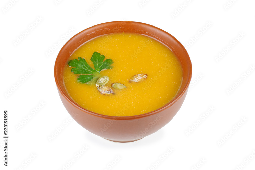 Ceramic bowl with pumpkin cream-soup isolated on white background Ceramic bowl with pumpkin cream-soup isolated on white background
