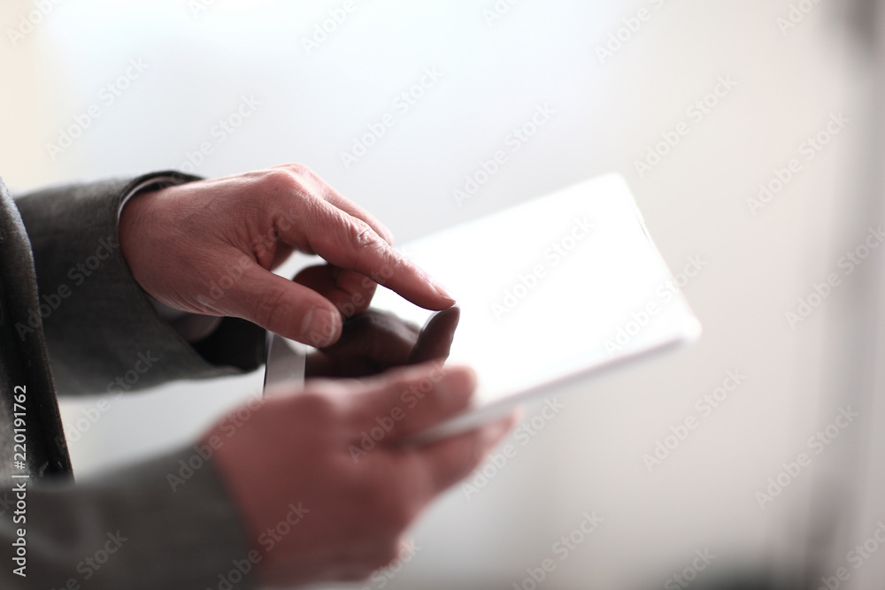 close up.businessman presses on the screen of a digital tablet.photo with copy space close up.businessman presses on the screen of a digital tablet.photo with copy space