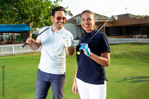 Couple at the course playing golf and looking happy
