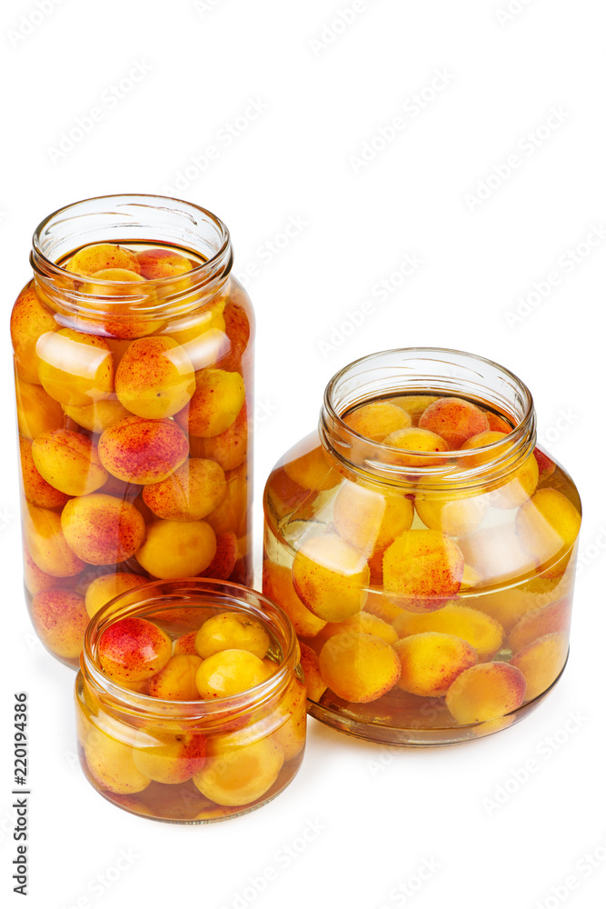 Apricots canned in glass jars isolated on white background Apricots canned in glass jars isolated on white background