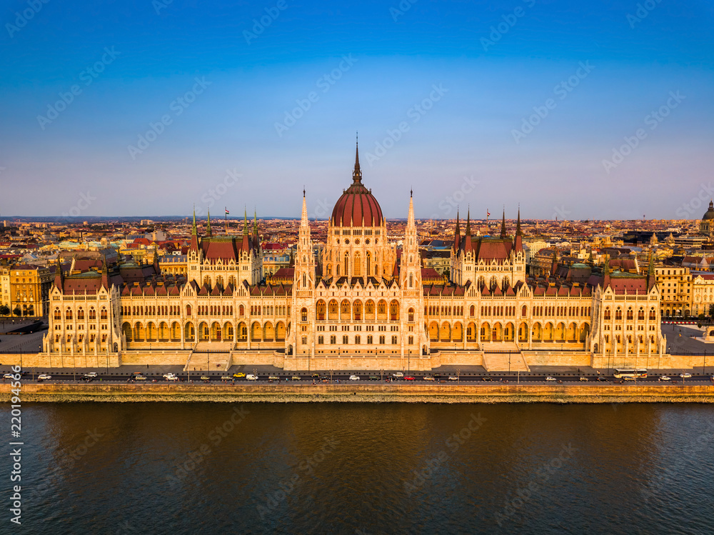 Budapest, Hungary - Aerial view of the beautiful Parliament of Hungary (Orszaghaz) at golden sunset with clear blue sky