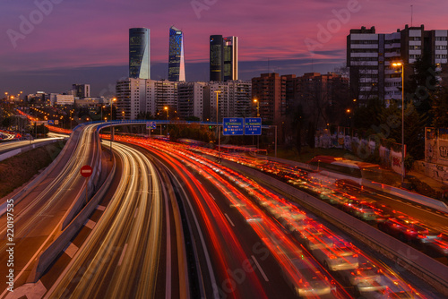 Long exposure photography at M30 highway with Madrid skyline (Four towers business area) as background, Spain