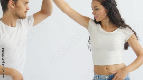 Social dance concept. Young romantic couple dancing on white background