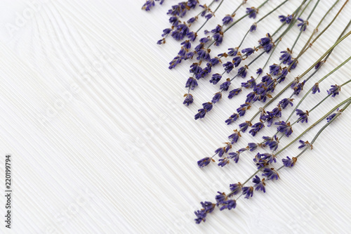 Fototapeta Naklejka Na Ścianę i Meble -  Dried flowers of lavender on white wooden background with copy space. Selective focus. Top view. Frame with lavander.