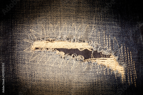 Vintage torn denim texture background.