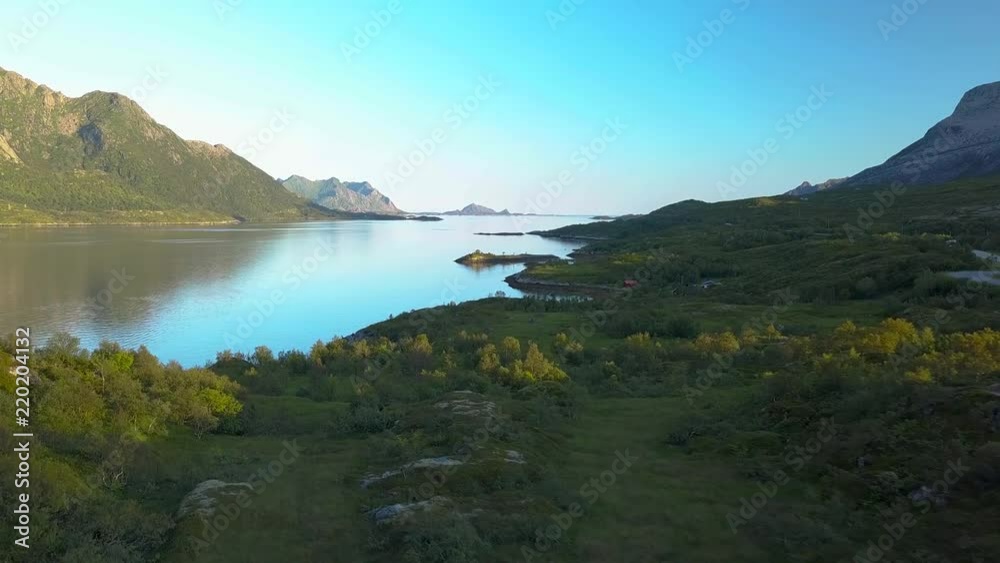 Flight over the fjord of northern Norway. Sunny weather and beautiful views of the bay and the mountains. Lofoten Islands. 4k Flight over the fjord of northern Norway. Sunny weather and beautiful views of the bay and the mountains. Lofoten Islands. 4k