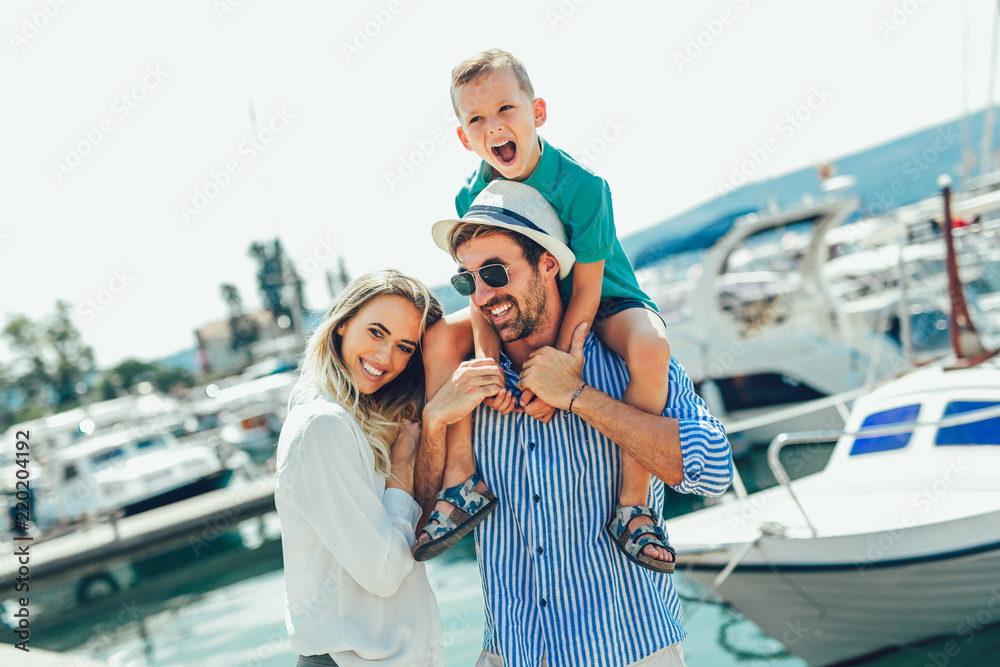 Fotografie Happy family having fun, enjoying the summer time by the sea.