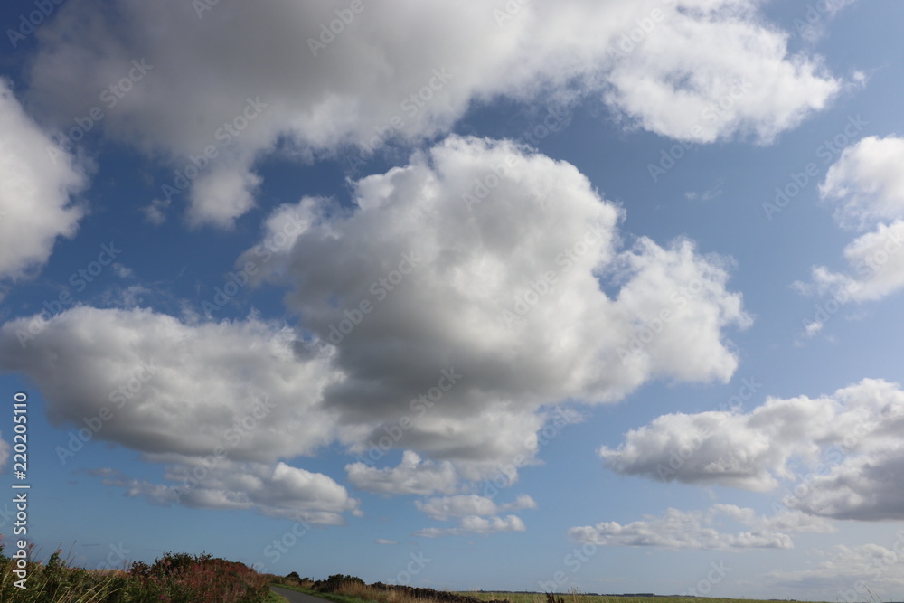 Clouds in blue sky over fields