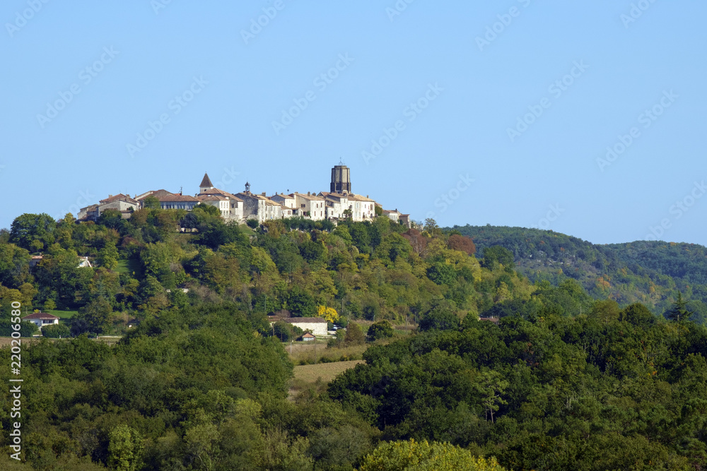 A long distance view across rural  Lot et Garonne countryside to the picturesque hilltop town of Tournon d'Agenais, France