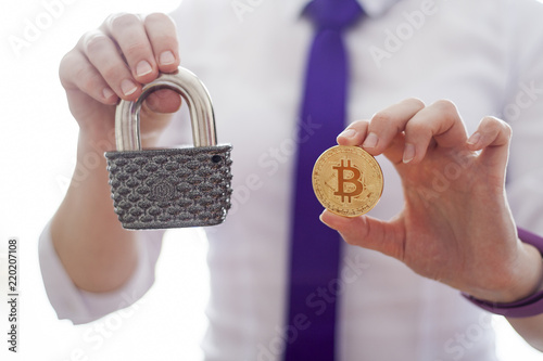 Business woman offers a gold crypto currency bitcoin and vintage padlock. Ddigital financial technology background. Template for text and icons. Secure fintech. photo