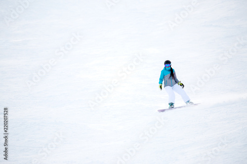 Photo of female athlete riding snowboard photo