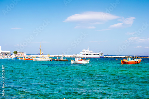 Fishing boats and voyage yacht near berth on the greece sea bay