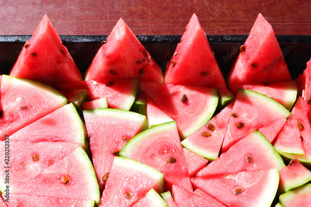 Pattern of watermelon slices. Pieces of ripe watermelon in old metal dishes. Red fruit with fructose for a diet. Cleansing the body with a diuretic meal. Vegetables for vegan Pattern of watermelon slices. Pieces of ripe watermelon in old metal dishes. Red fruit with fructose for a diet. Cleansing the body with a diuretic meal. Vegetables for vegan