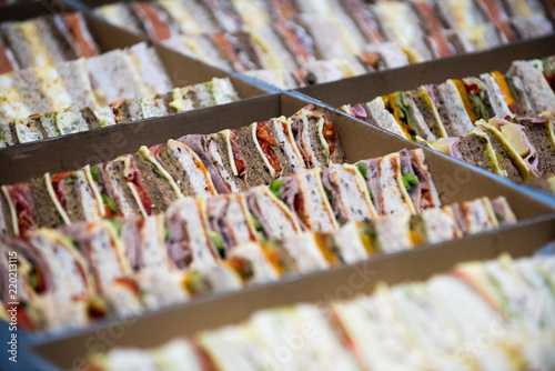 Photos sandwiches cut in to triangles served as catering at an event