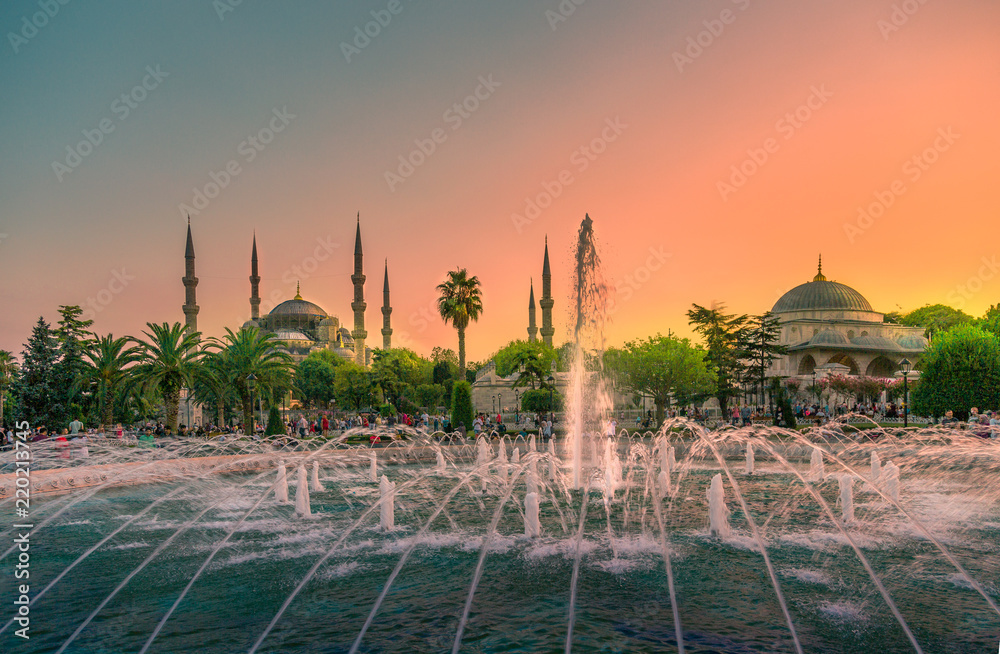 Blue Mosque at night with golden illumination, wide view of Istanbul in ...