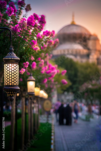 Blue Mosque at night with golden illumination, wide view of Istanbul in dusk. Sultanahmet Camii mosque with six minarets - famous islamic monument of the Ottoman architecture in Turkey.