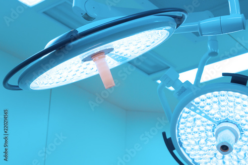 Two surgical lamps in operation room take with art lighting and blue filter