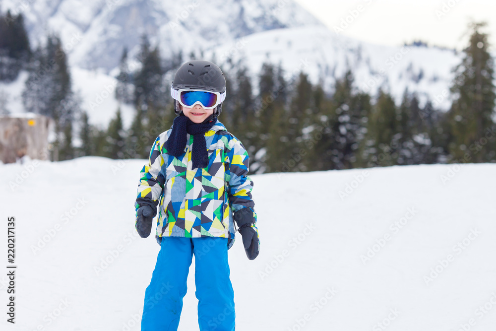 Young child, skiing on snow slope in ski resort in Austria Young child, skiing on snow slope in ski resort in Austria