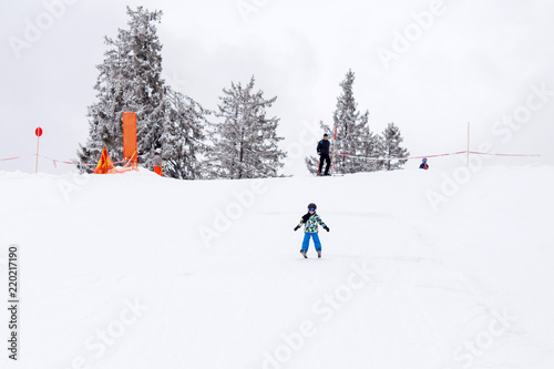 Cute preschool child, boy, skiing happily in aAustrian ski resort, wintertime