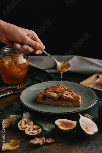 partial view of woman pouring honey on piece of homemade pie © LIGHTFIELD STUDIOS