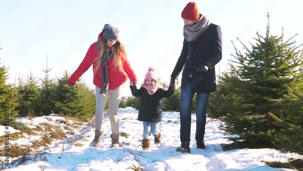 Parents with child running in forest