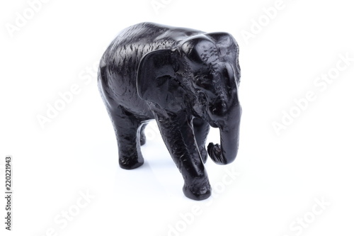 Fototapeta Naklejka Na Ścianę i Meble -  Black elephant like wooden carving with white ivory. Stand on white background, Isolated, Art Model Thai Crafts, For decoration Like in the spa.