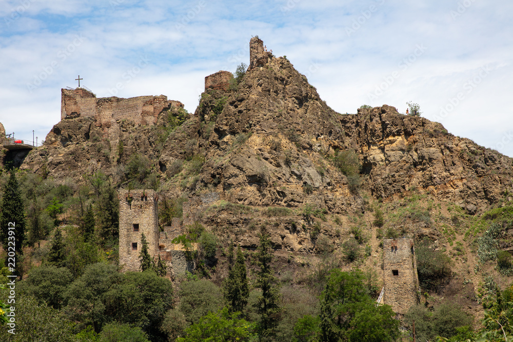 panorama of  ruined fortress and towers on rock