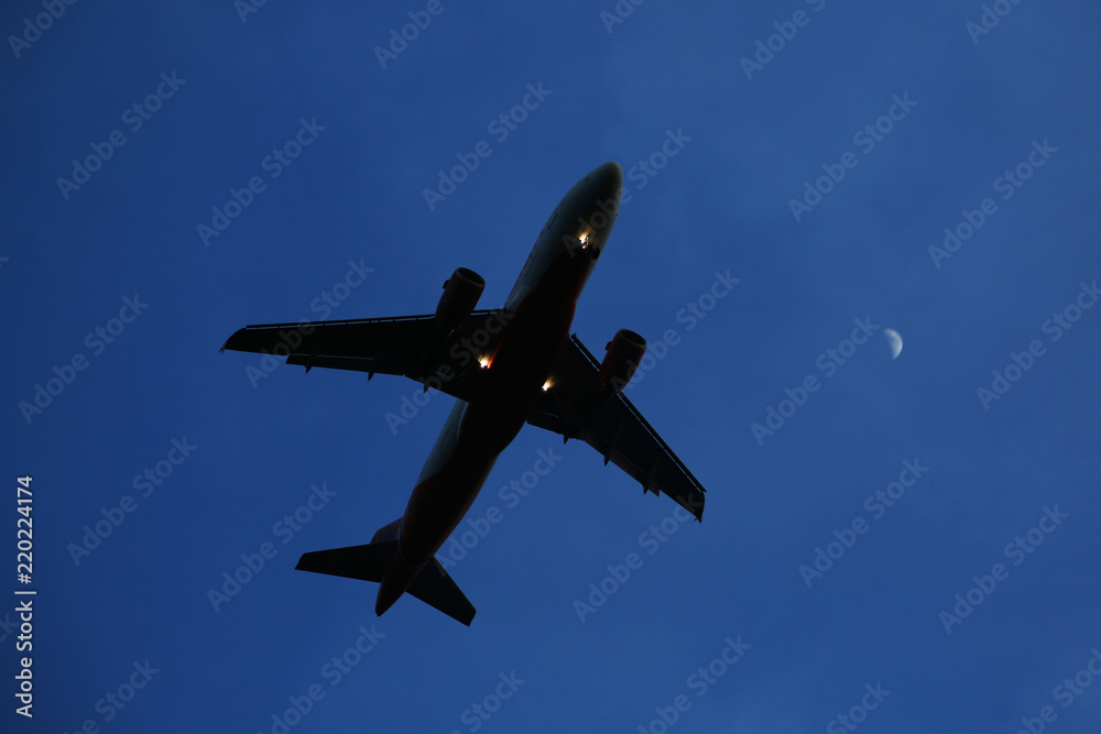 The airplane is flying against the blue sky in the sun The airplane is flying against the blue sky in the sun
