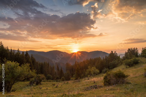 Panoramic view of colorful sunrise in mountains.