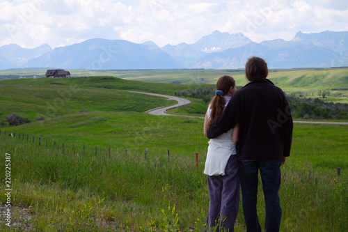 Couple enjoy the view of the Rocky Mountains  Alberta  Canada 