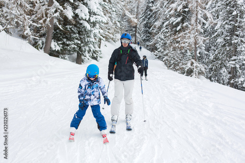 Father and child, skiing together in Austrian resort