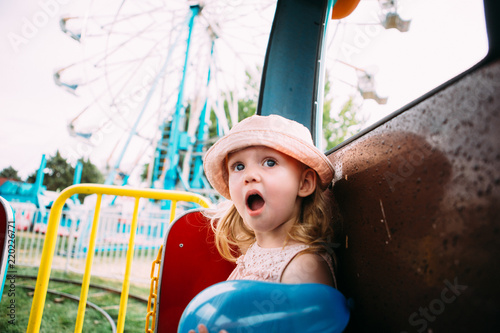 Slika na platnu Toddler girl with awestruck face expression at the fair