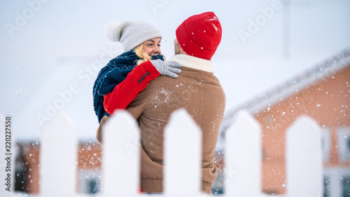 Photography Handsome Young Couple Embrace and Happily Smile, Snow Falls on them