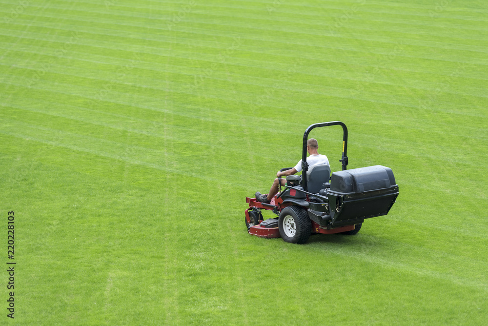 Obraz premium Mowing grass at the football stadium