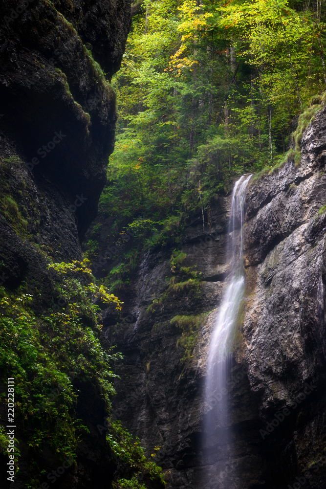 Detail of waterfall in forest. Foggy season in Partnach Gorge near Garmisch-Partenkirchen, Bavaria, Germany. Detail of waterfall in forest. Foggy season in Partnach Gorge near Garmisch-Partenkirchen, Bavaria, Germany.