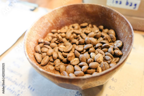 Arabica coffee beans in wooden bowl on table