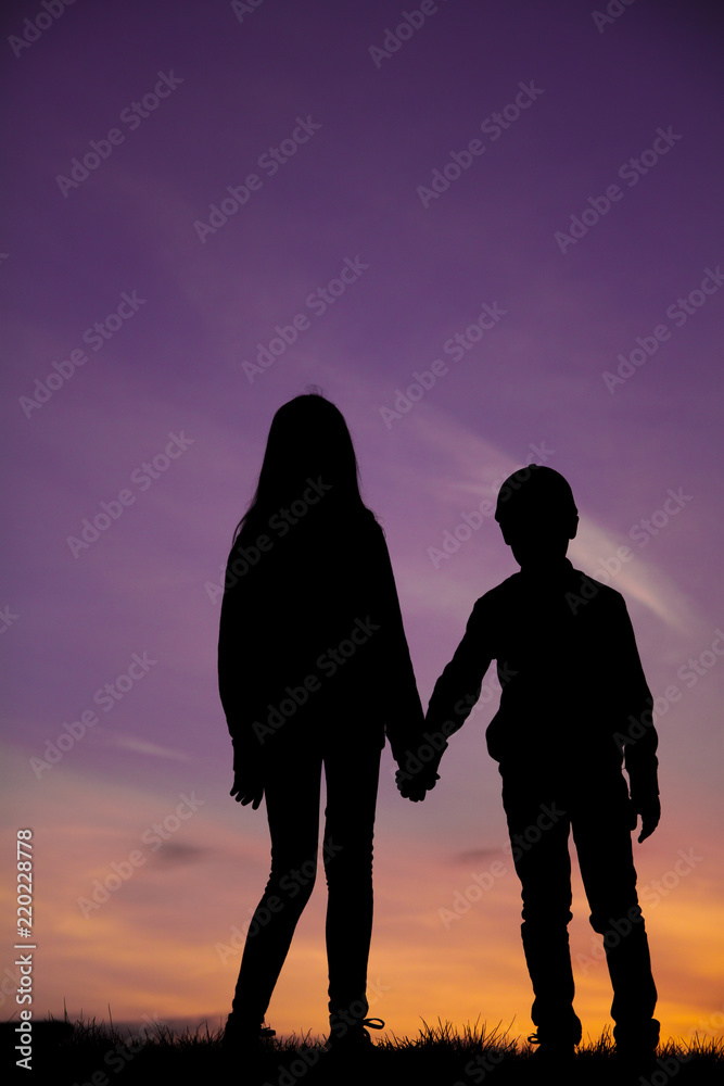 Silhouettes of children on a sky background