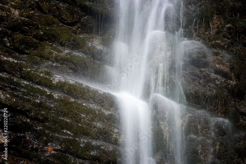 Detail of waterfall in forest. Foggy season in Partnach Gorge near Garmisch-Partenkirchen, Bavaria, Germany.
