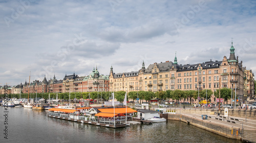 Boat and street cafe in old part of Stockholm, view from the river, 2 august 2018 Sweden