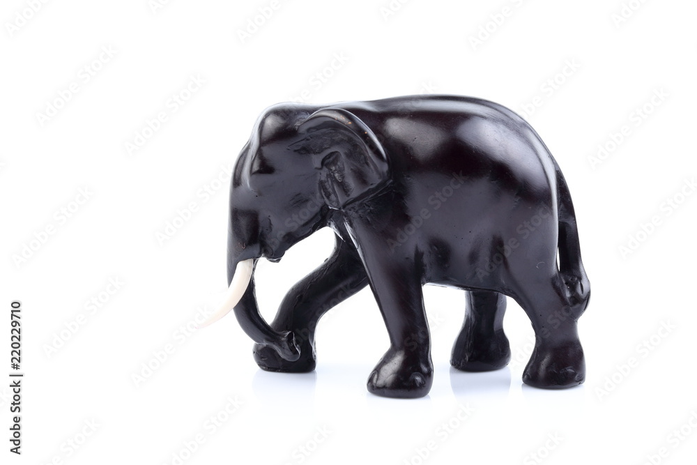 Black elephant like wooden carved with white ivory. Stand on white background, Isolated, Art Model Thai Crafts, For decoration Like in the spa.