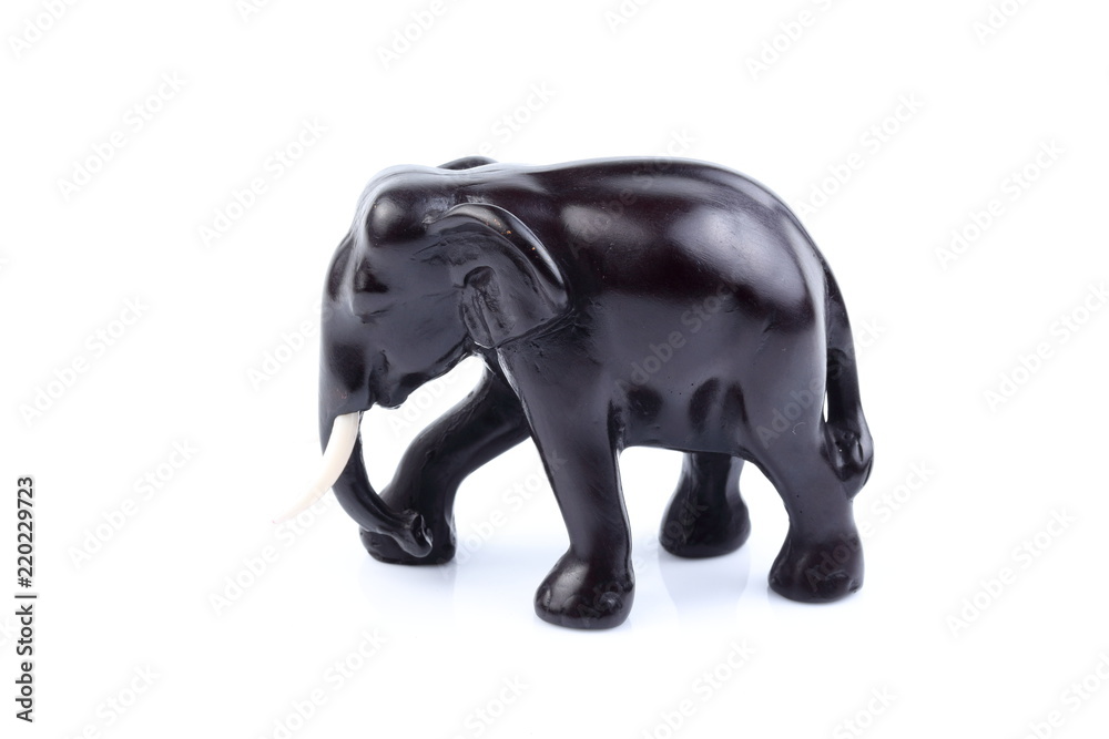 Obraz premium Black elephant like wooden carved with white ivory. Stand on white background, Isolated, Art Model Thai Crafts, For decoration Like in the spa.