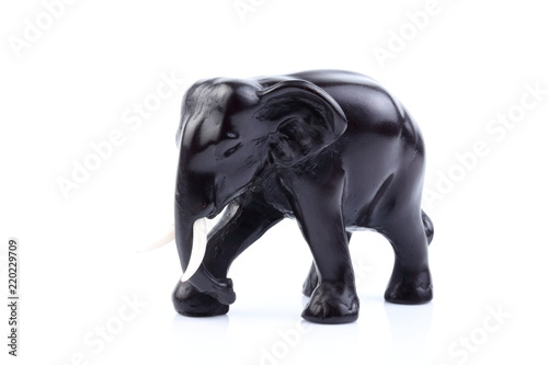 Black elephant like wooden carved with white ivory. Stand on white background  Isolated  Art Model Thai Crafts  For decoration Like in the spa.