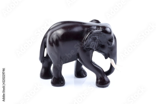 Black elephant like wooden carved with white ivory. Stand on white background, Isolated, Art Model Thai Crafts, For decoration Like in the spa. © Thanachai