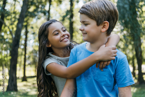 cute happy children hugging and smiling in park © LIGHTFIELD STUDIOS