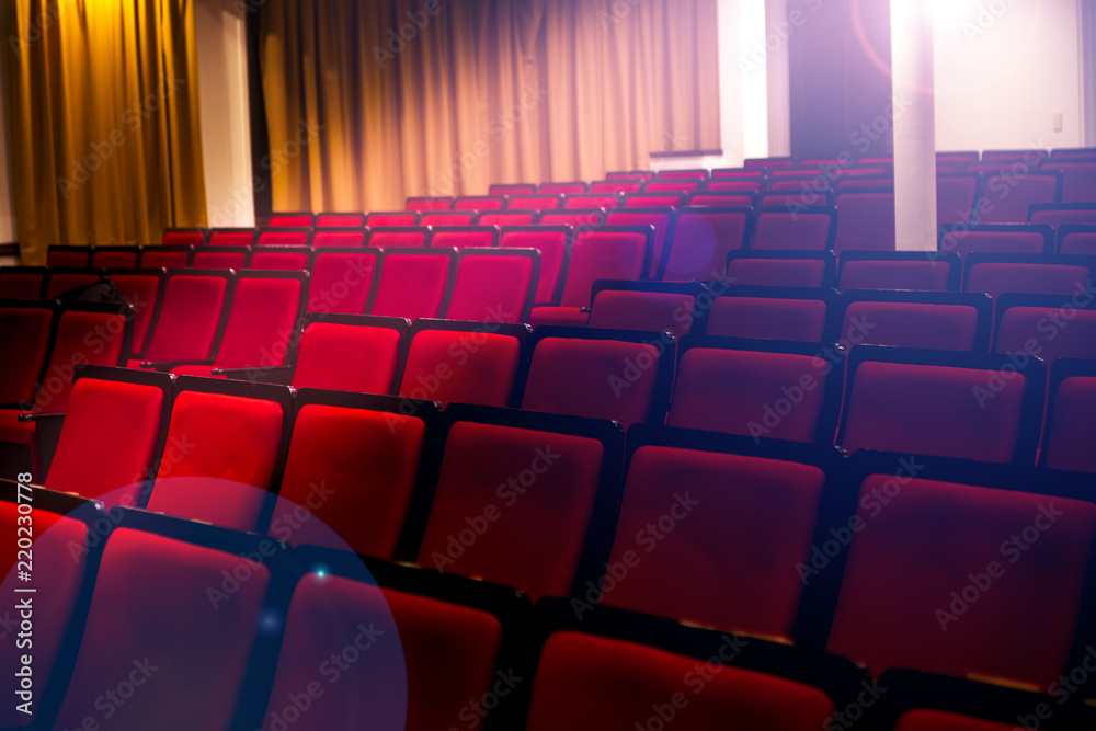 Fototapeta premium Auditorium in a theater or cinema, spotlights pass through empty seats