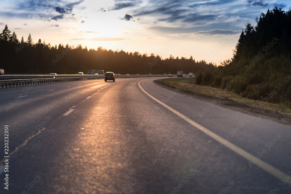 Car and light on the evening road. Sunset Car and light on the evening road. Sunset