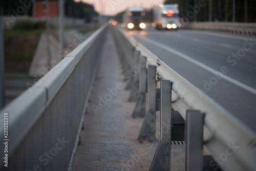Anodized safety steel barrier on freeway bridge, close up
