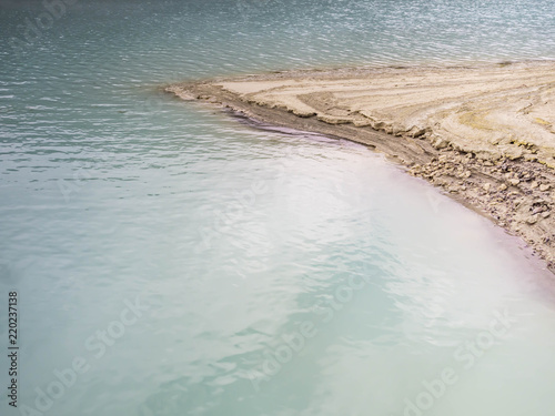 Abstract nature background of volcanic lake and sand.