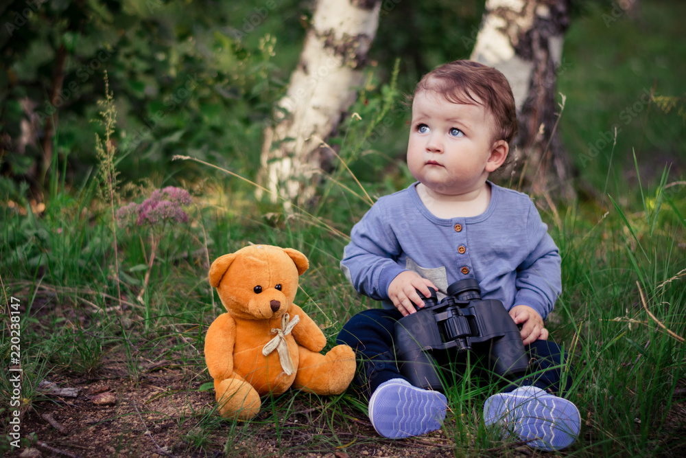 Little boy playing with binoculars in the woods Little boy playing with binoculars in the woods