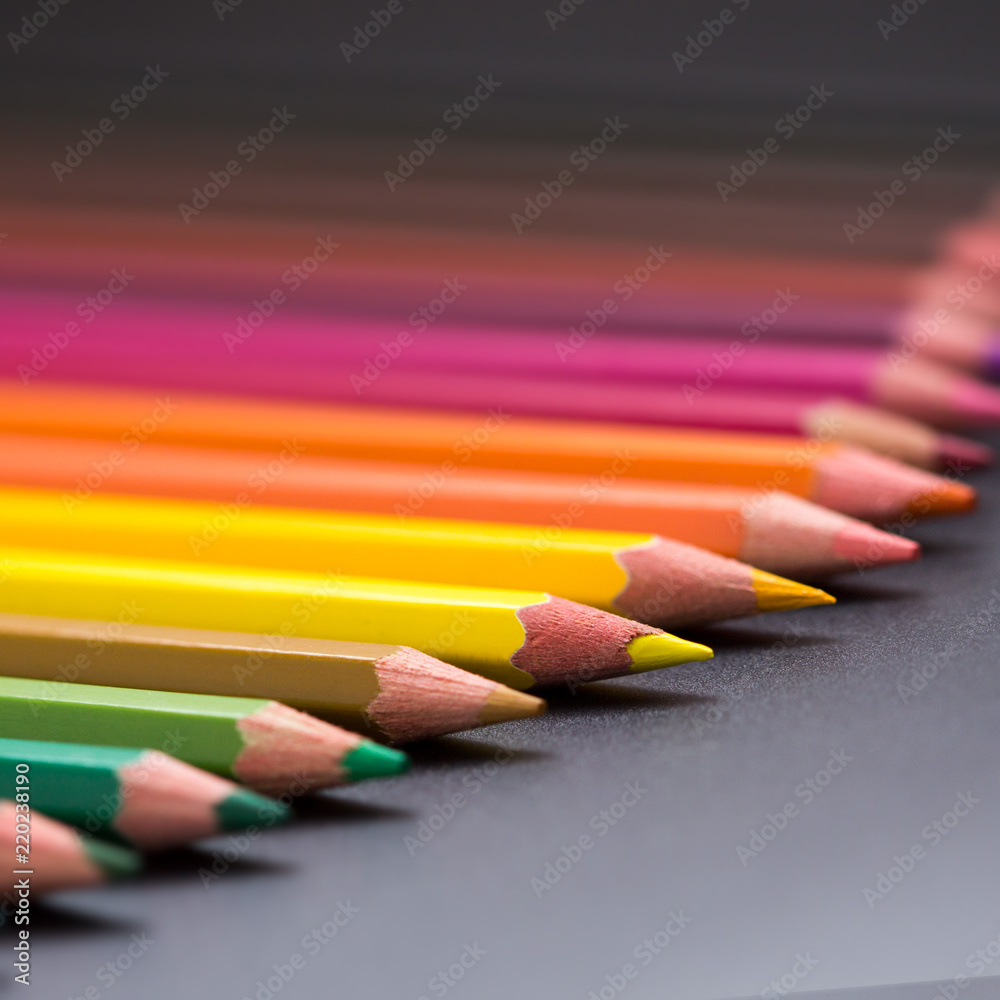 color pencils on black background close up. color pencils on black background close up.